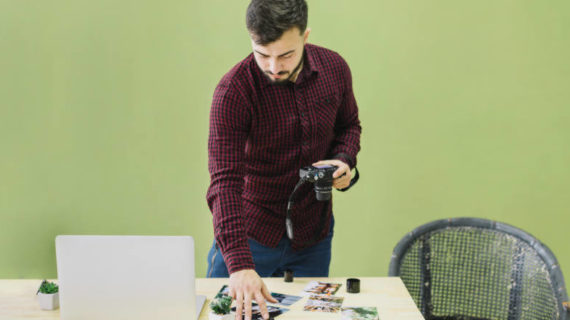 man holding his camera