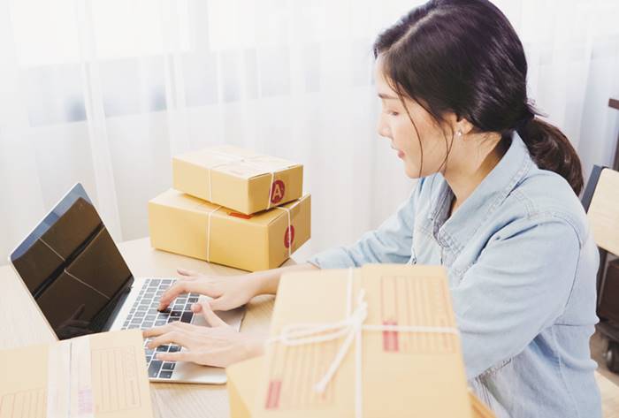 woman smiling while working on her laptop