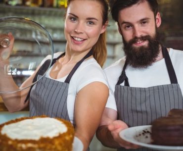 man and woman holding cake