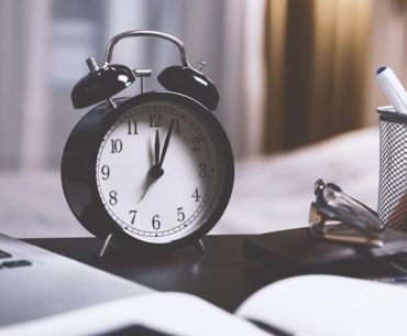 black alarm clock on desk