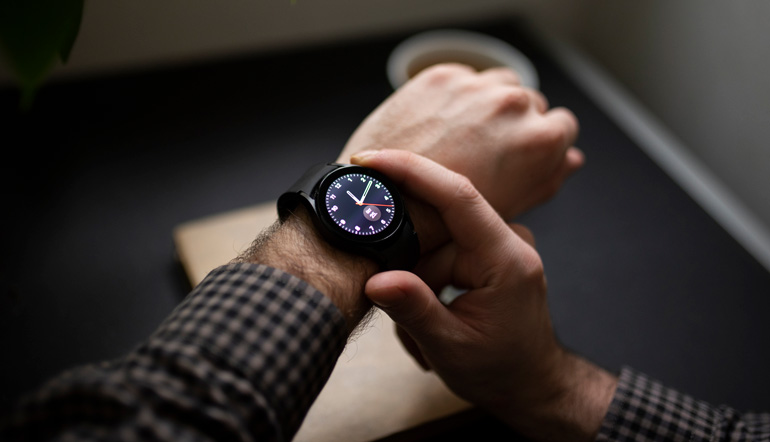 man holding wrist watch