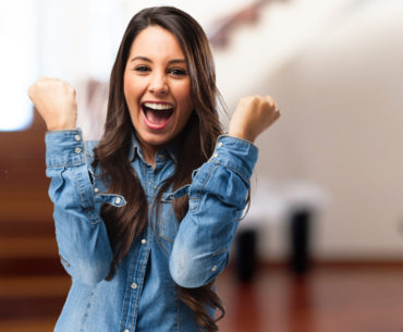 over excited young woman wearing denim shirt