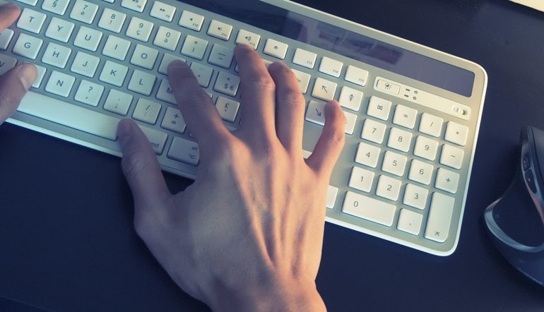 person typing on white keyboard