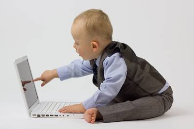 baby boy touching the laptop screen