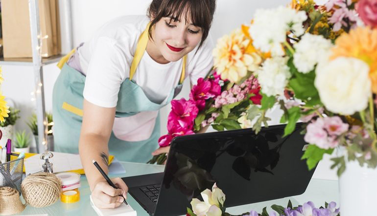 happy female florist writing