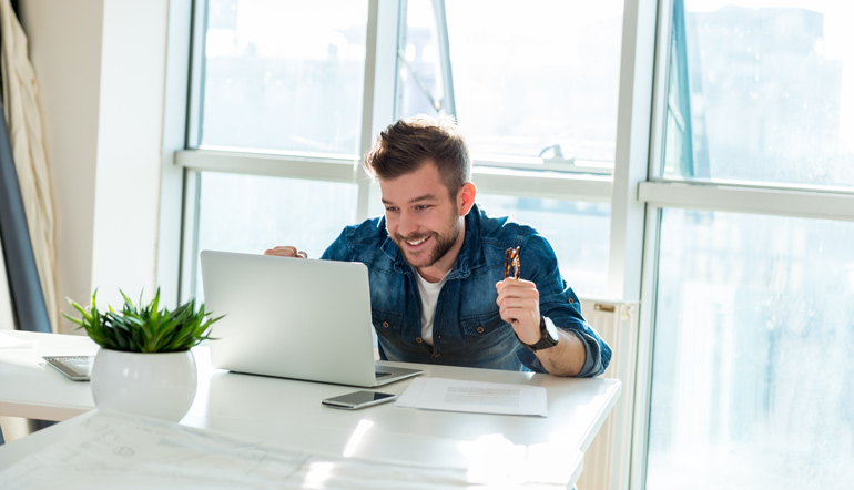 excited man looking at the computer