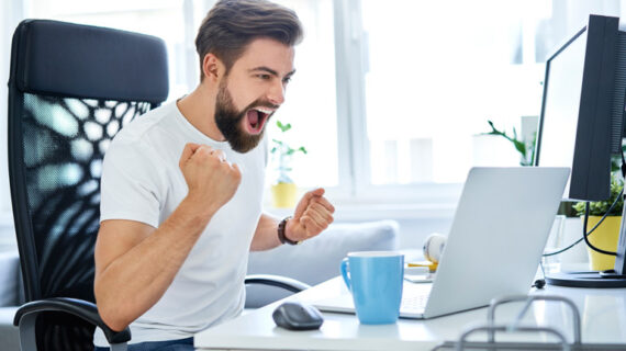 successful man screaming excited working from home