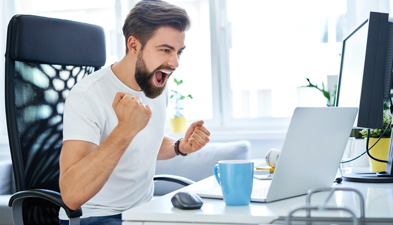 successful man screaming excited working from home