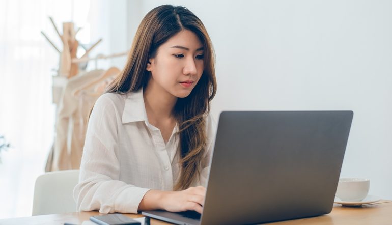 young woman busy working on her laptop