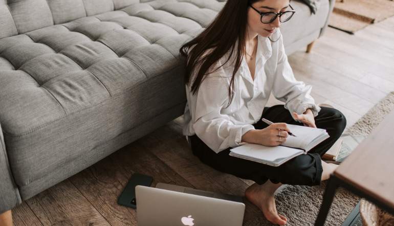 woman writing on notebook