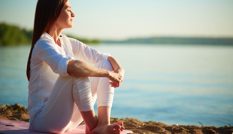 woman relaxing by the shore