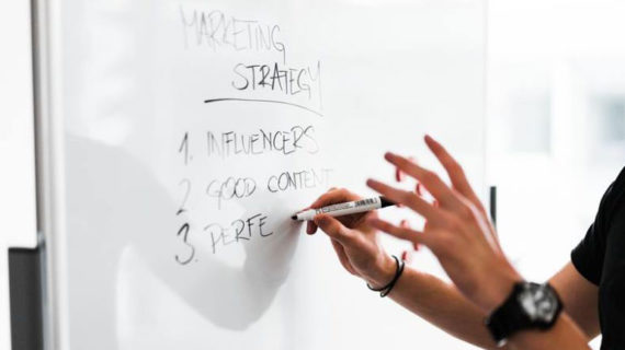 person writing on the white board