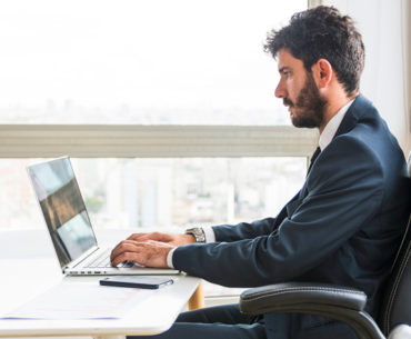 Businessman sitting and working on laptop