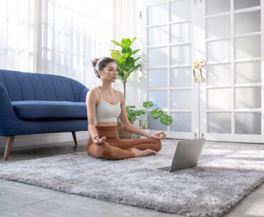 young asian woman doing yoga at home