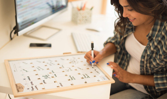 woman writing on calendar