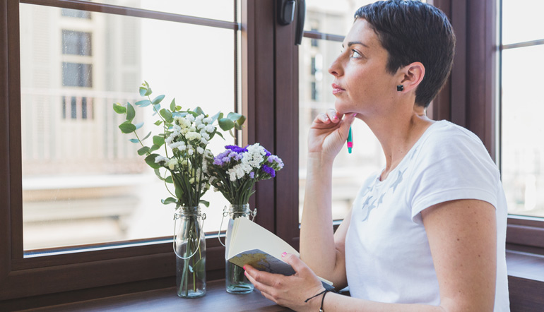 Woman thinking and looking through the window