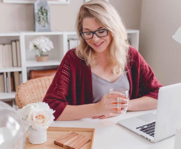 young female working while drinking tea