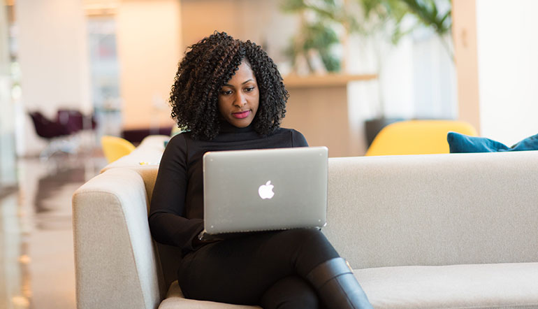 Woman working on the sofa with her laptop