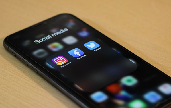 black smartphone on brown table