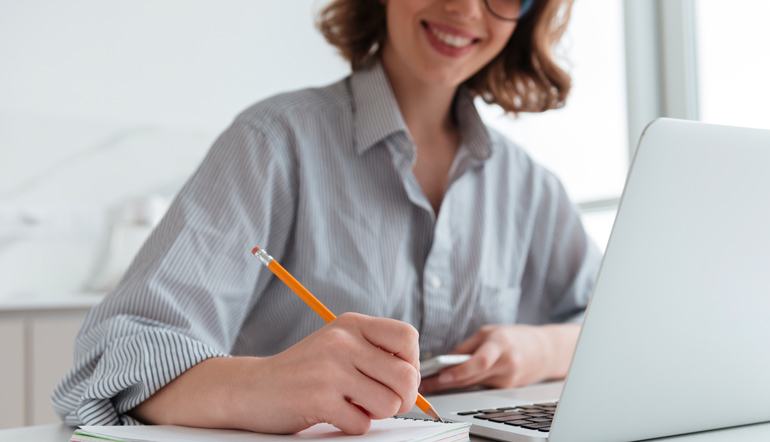 cheerful woman taking down notes