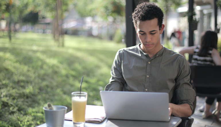 black male freelancer using laptop