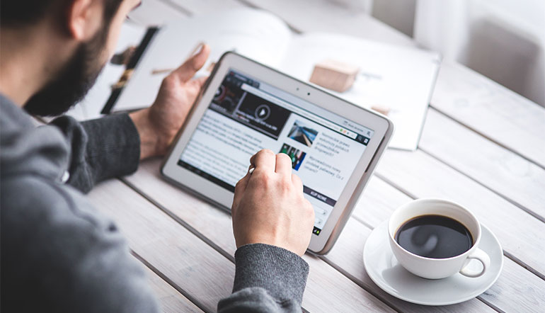 Man reading news on his tablet