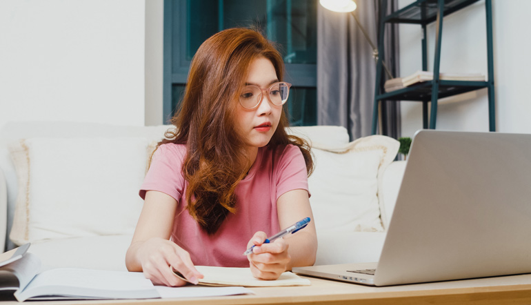 Young asia teen girl working using laptop