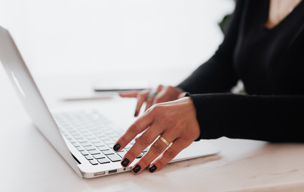 woman wearing black using laptop