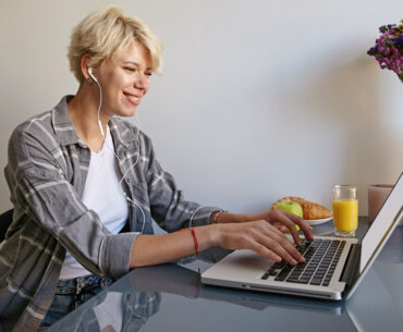 cheerful woman with silver laptop