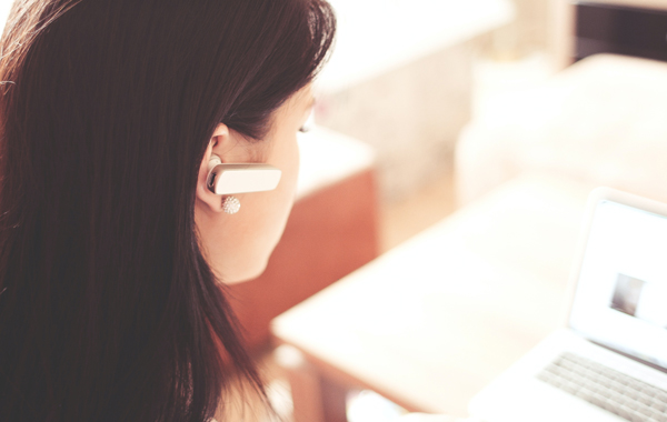 Woman wearing earpiece