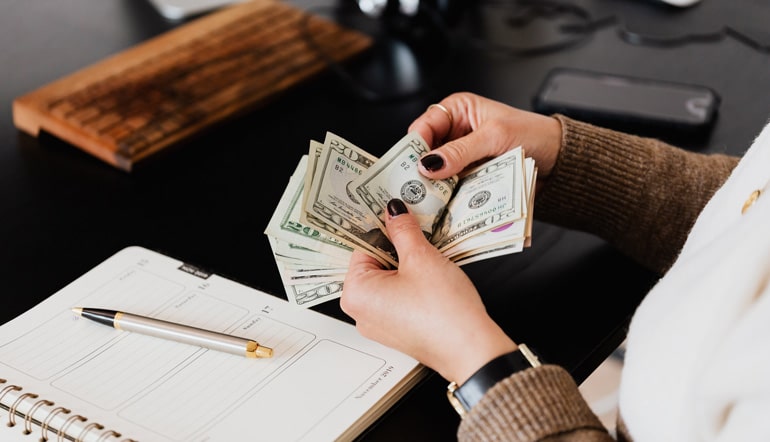 Crop woman counting money