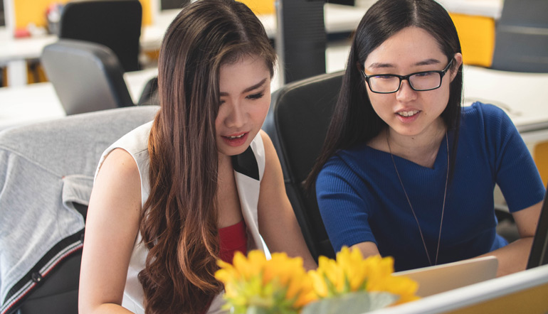 Two woman working online