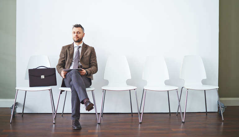 man wearing corporate attire waiting for interview