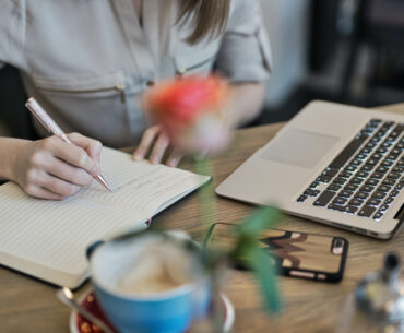 Person writing on a notebook