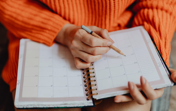 woman writing schedule