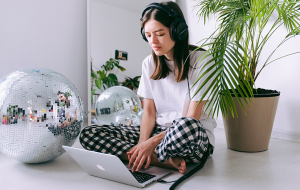 A lady proofreading a transcription at home in pajamas