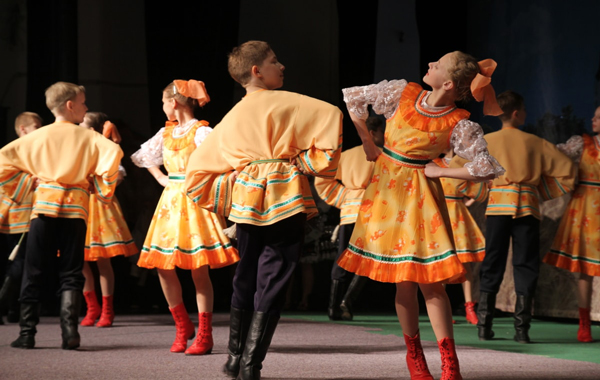 boys and girls dancing in a theatre performance