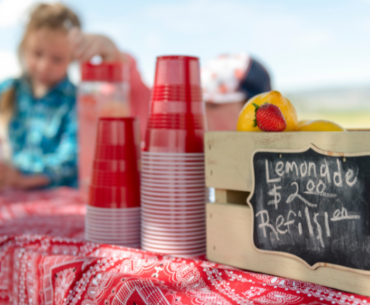 Children sell drinks at lemonade stand
