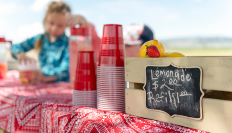 Children sell drinks at lemonade stand