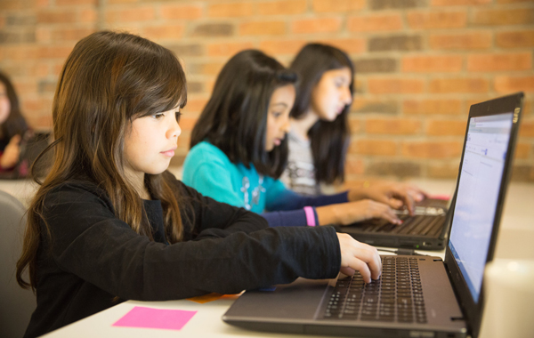 kids with laptops learning to code