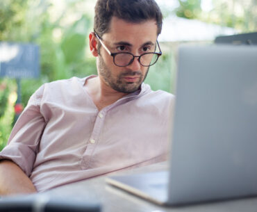 male looking seriously on his laptop