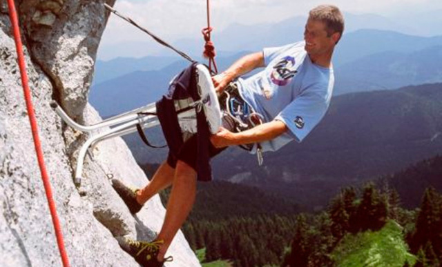 man ironing clothes while rock climbing