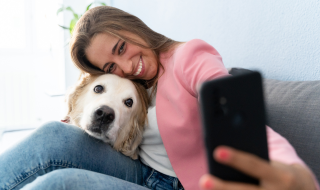 woman taking selfie with her dog