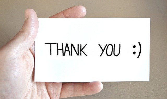 man holding a thank you card