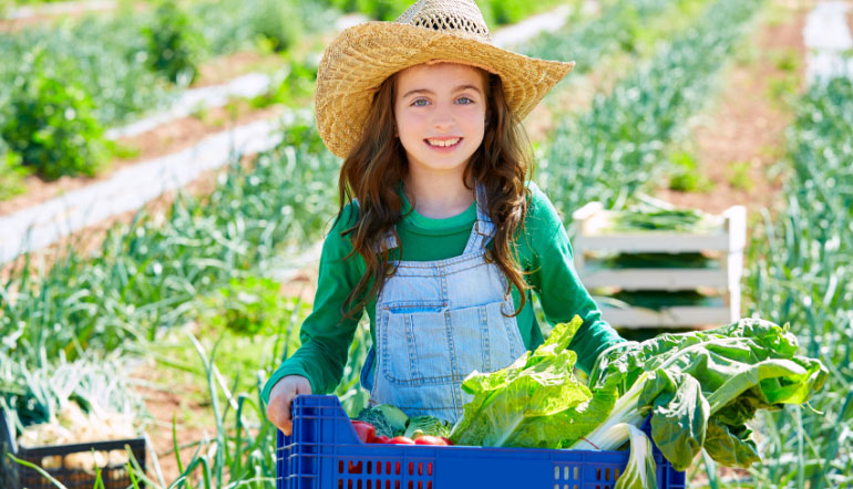 girl harvesting vegetables