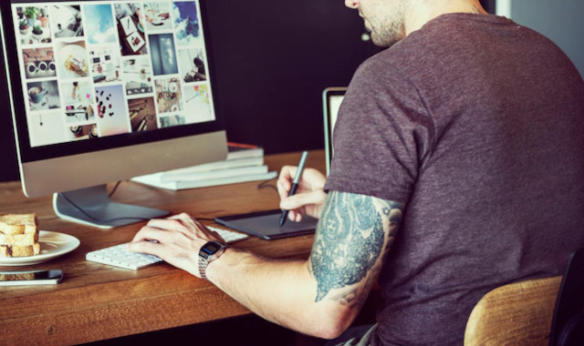 man editing photos on a computer