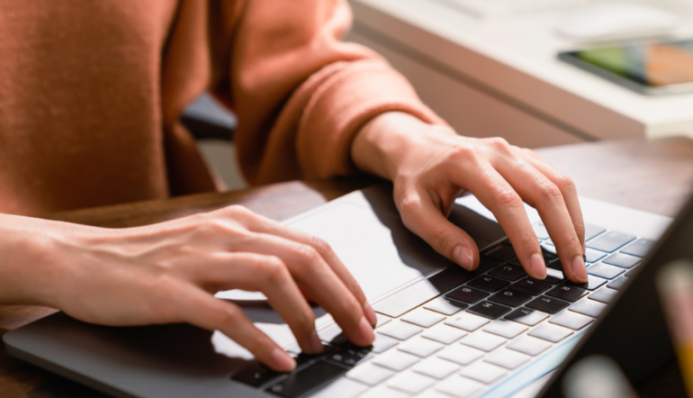 person typing using laptop