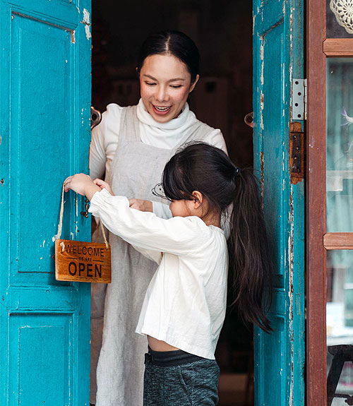 mother and daughter opening a cafe