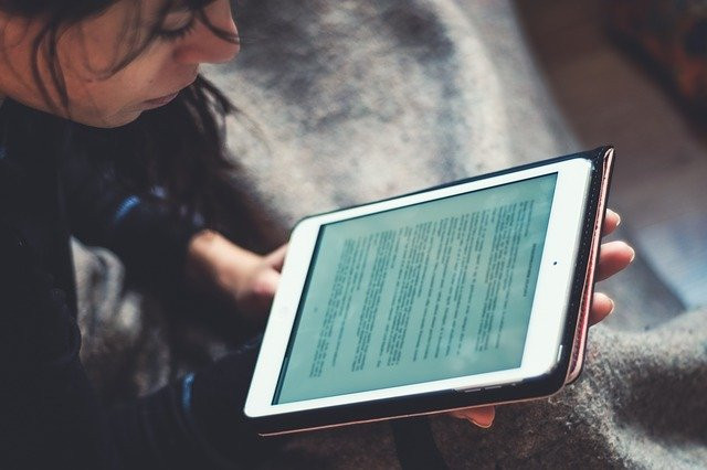 woman reading on a tablet