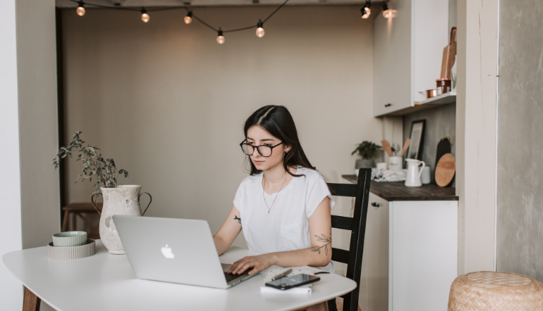 young businesswoman using laptop at home